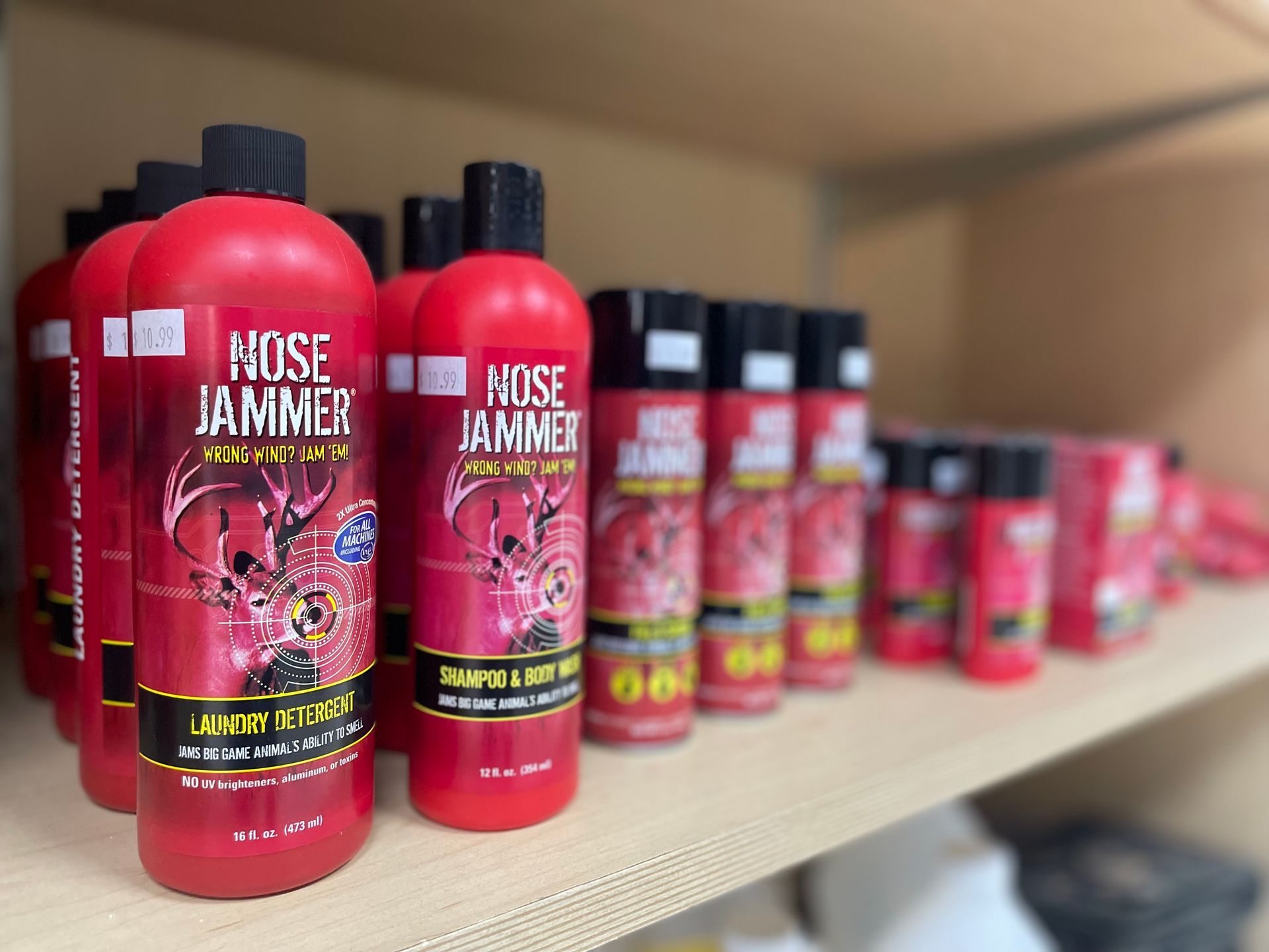 Shelves holding multiple red bottles of 