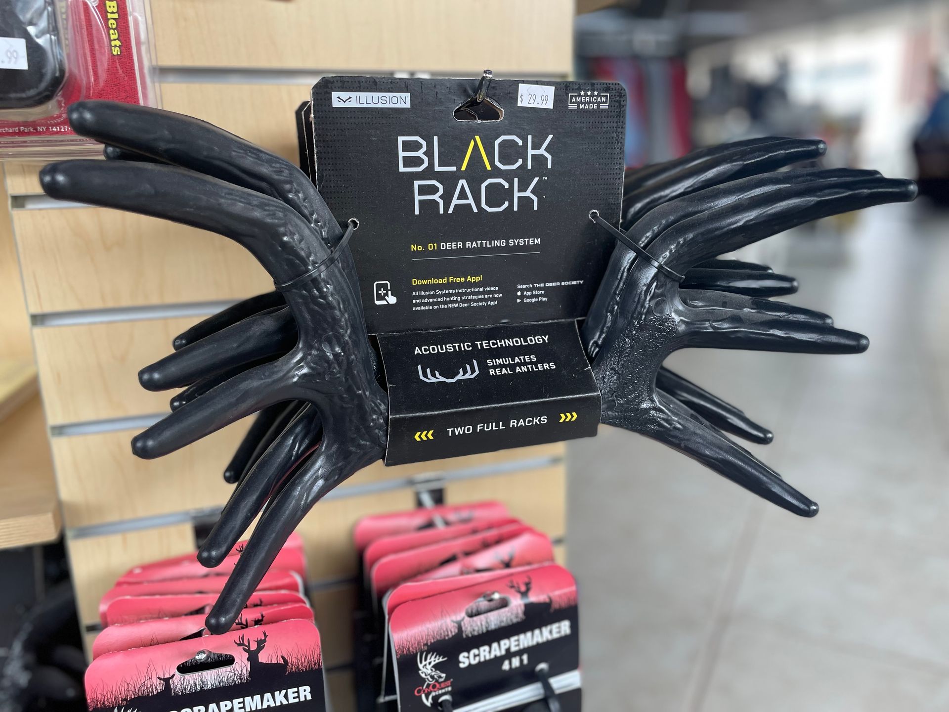 Black antler-shaped rack on display with product packaging, set in a store.