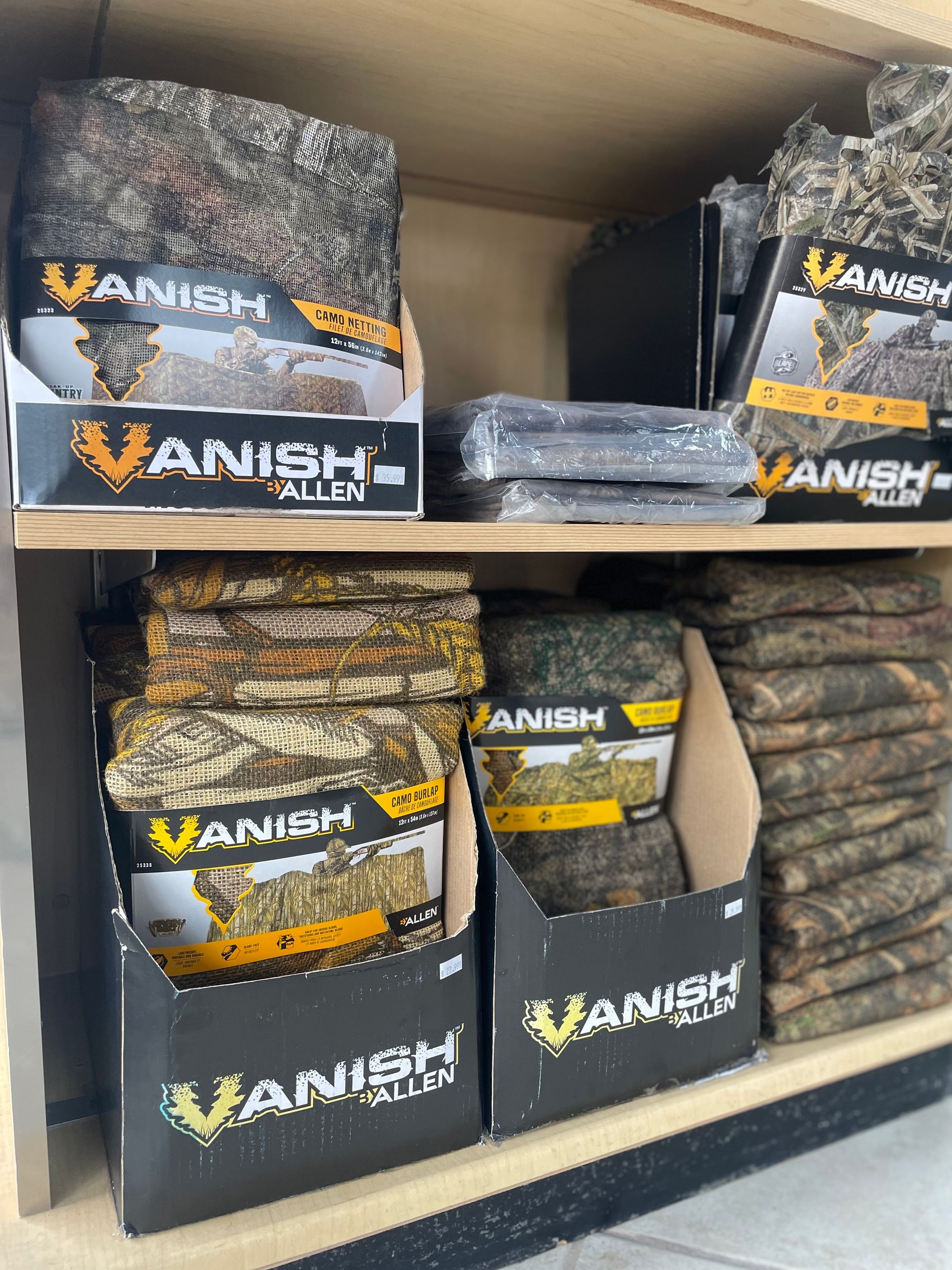 Shelves stocked with Allen Vanish camouflage material in various patterns and colors.