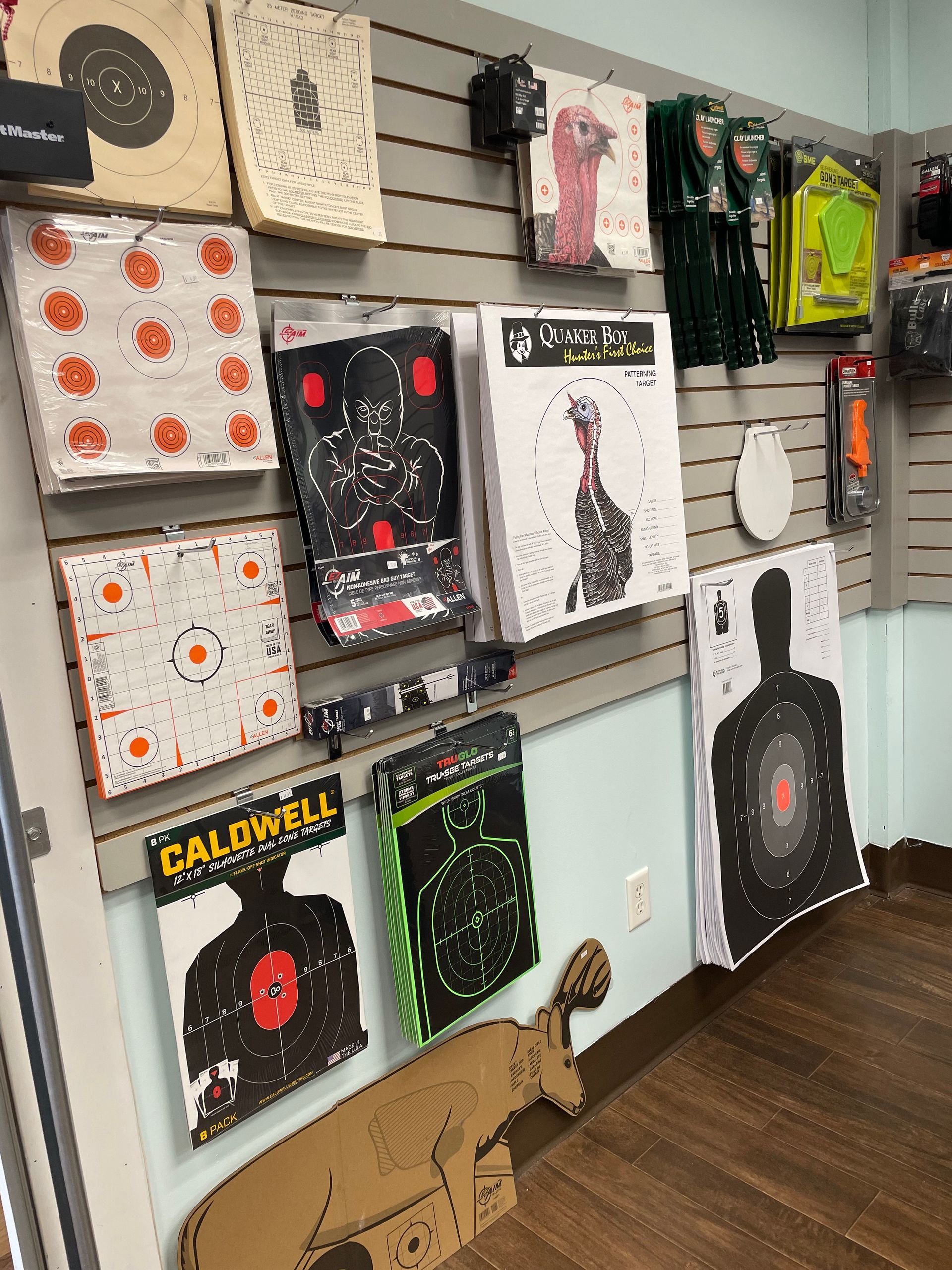 A wall with a lot of targets on it including one that says caldwell