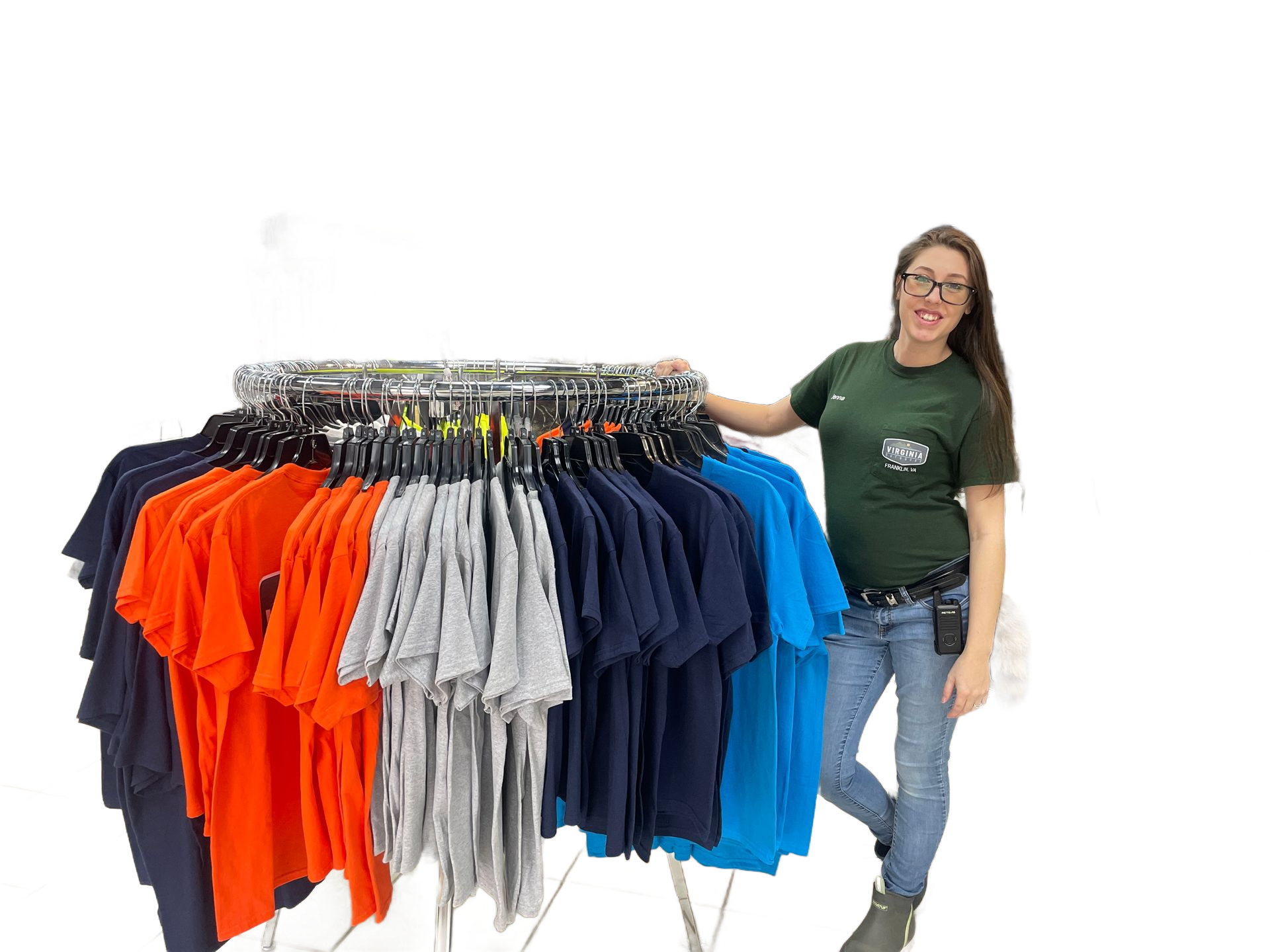 A woman is standing in front of a rack of shirts in a store.