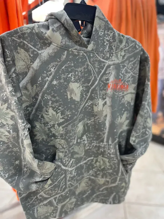 Gray camo hoodie with red logo hanging on a clothing rack