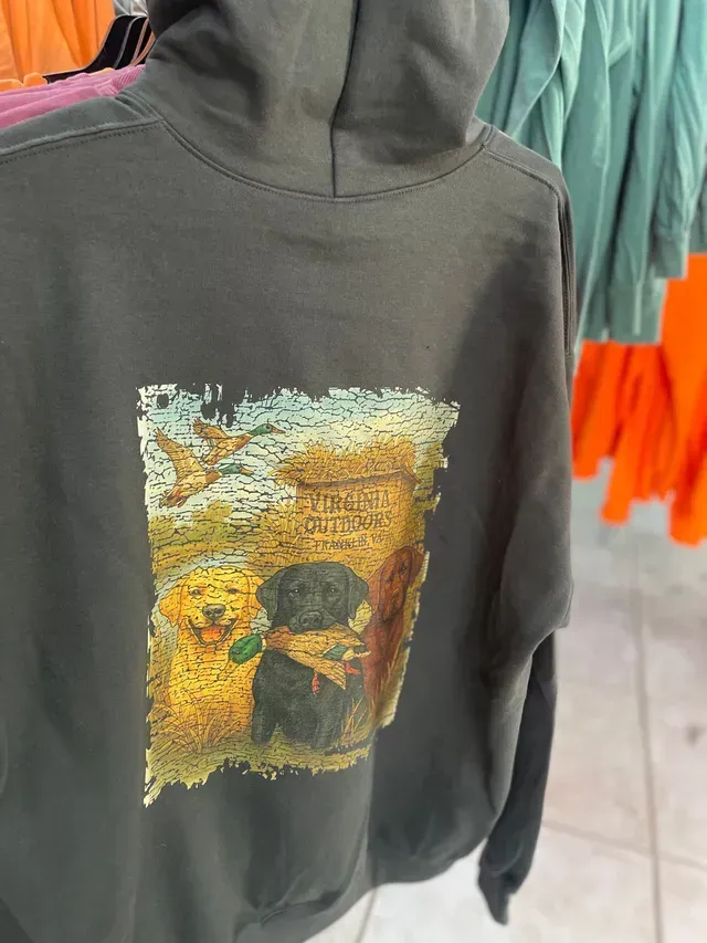 Dark gray hoodie with a colorful graphic print on the chest, hanging on a rack.