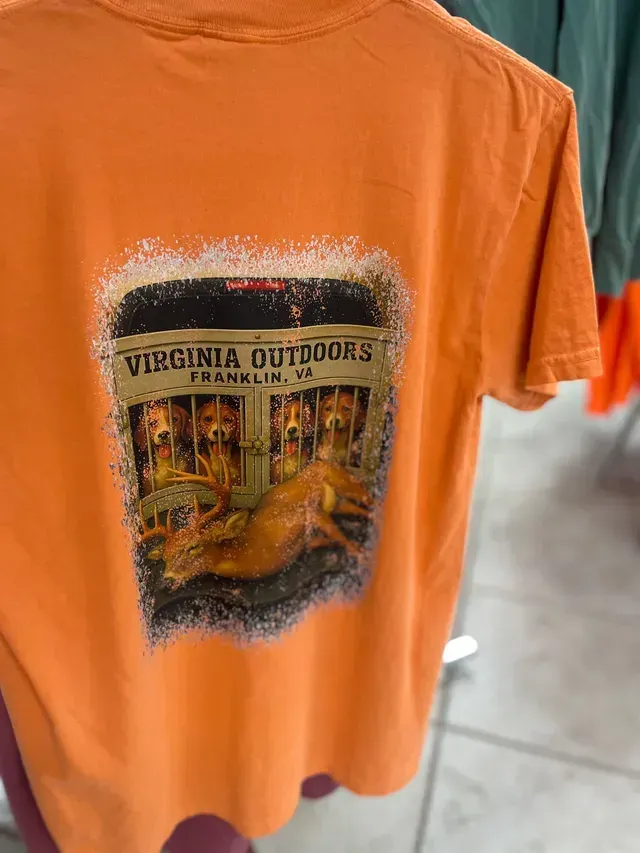 Orange T-shirt with Virginia Outdoors graphic on the back, hanging on a rack