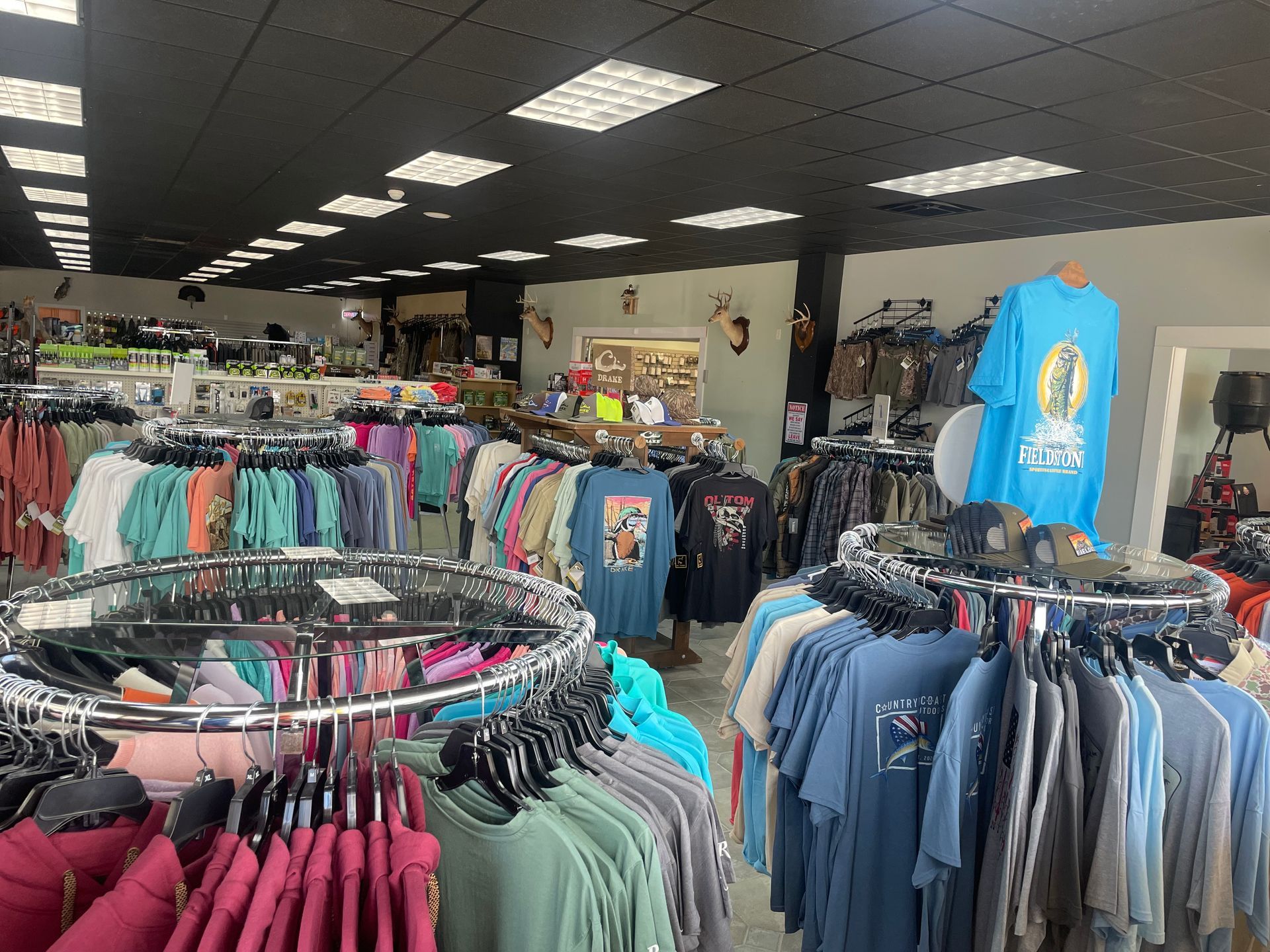A store filled with lots of clothes hanging on racks.