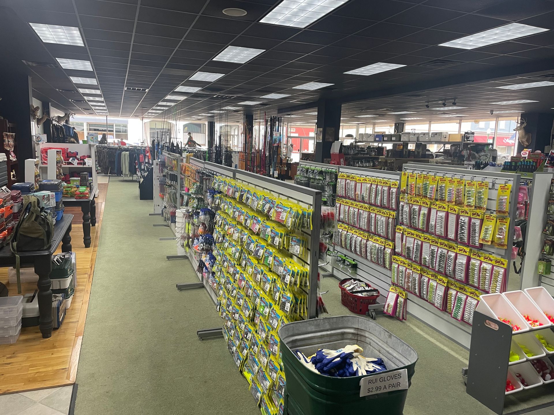 A store aisle with shelves of colorful packaged goods under bright ceiling lights.