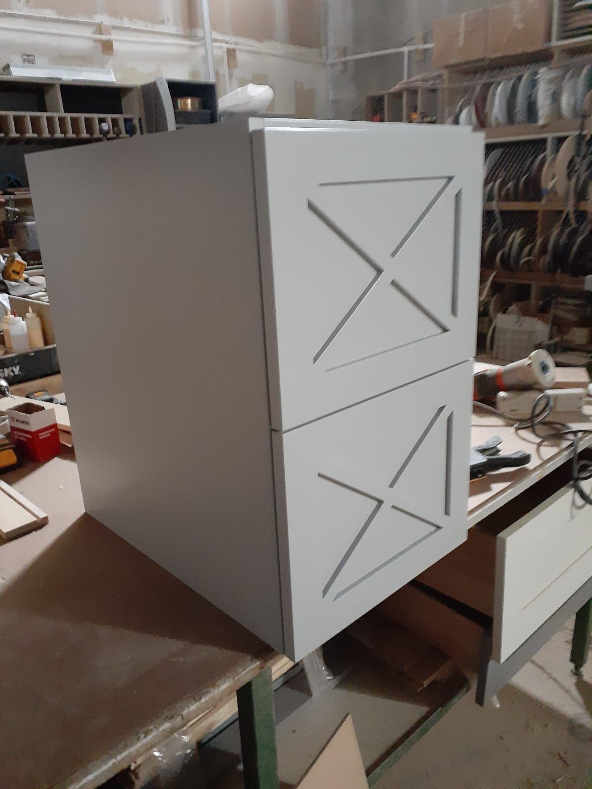 Two-drawer cabinet with light gray doors and decorative 