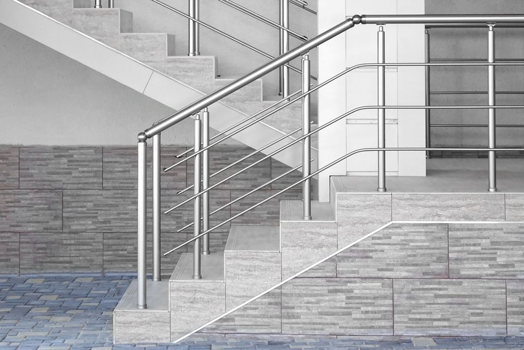 Staircase with metal railings and stone walls in a modern gray building