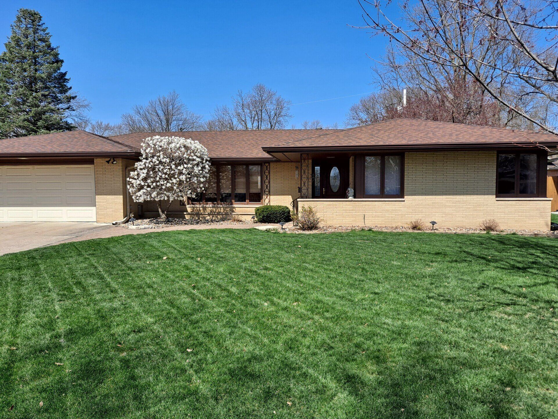 shingle roof house with lawn
