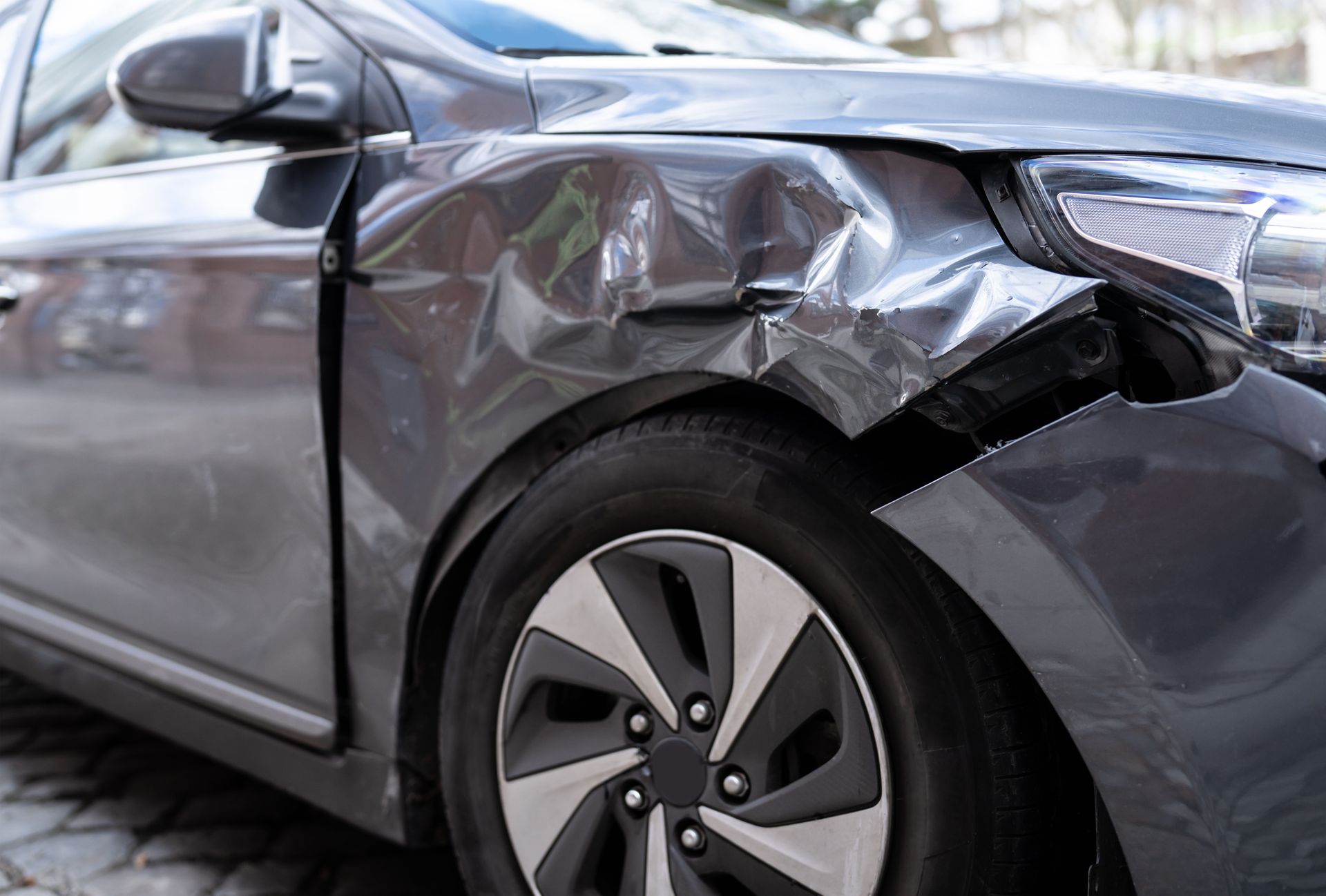 A car with a damaged hood is shown on a white background