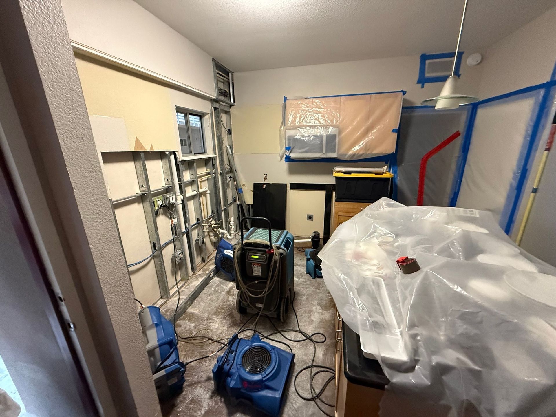 A room with a lot of plastic covering the floor and walls.