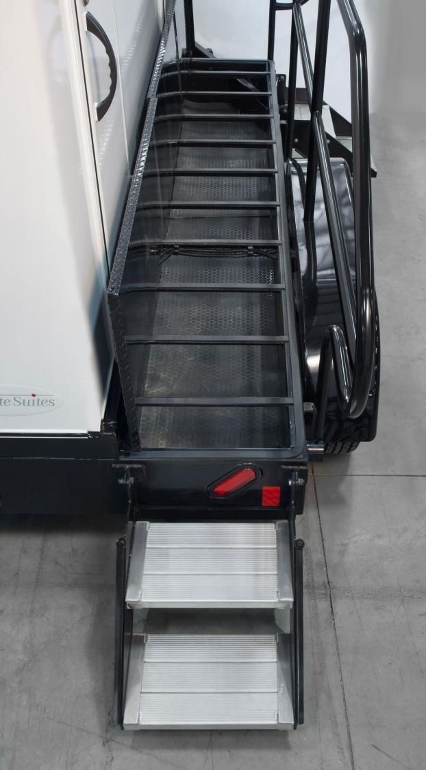 A staircase with steps leading up to a restroom trailer
