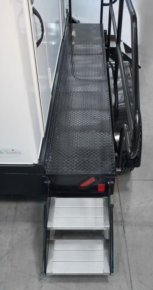 A staircase with steps leading up to a restroom trailer