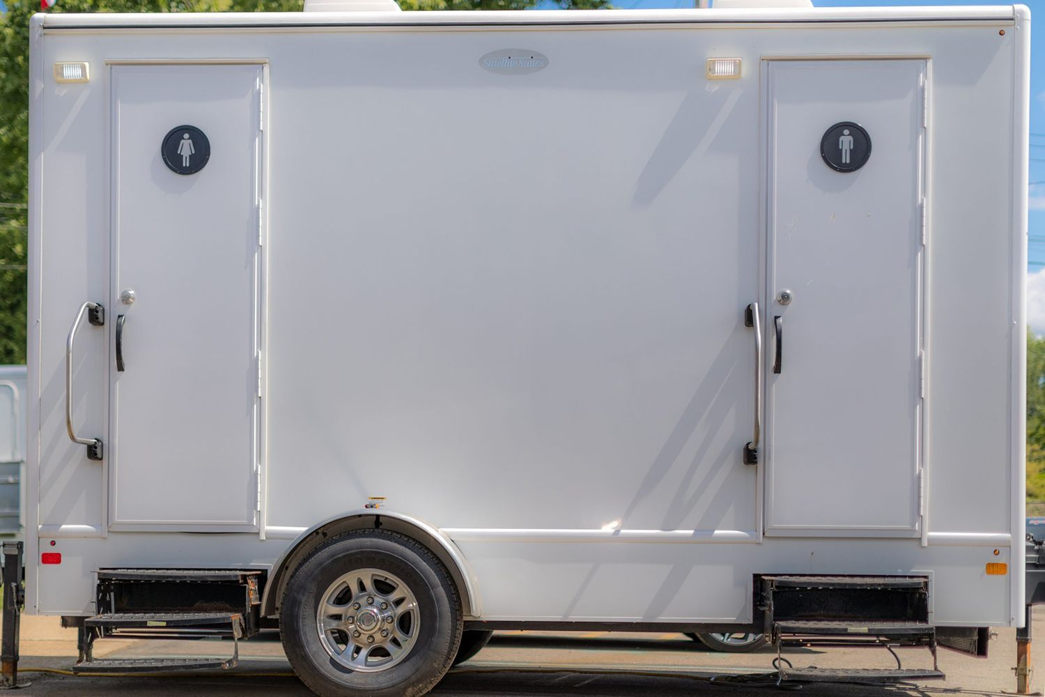 A white luxury portable restroom trailer