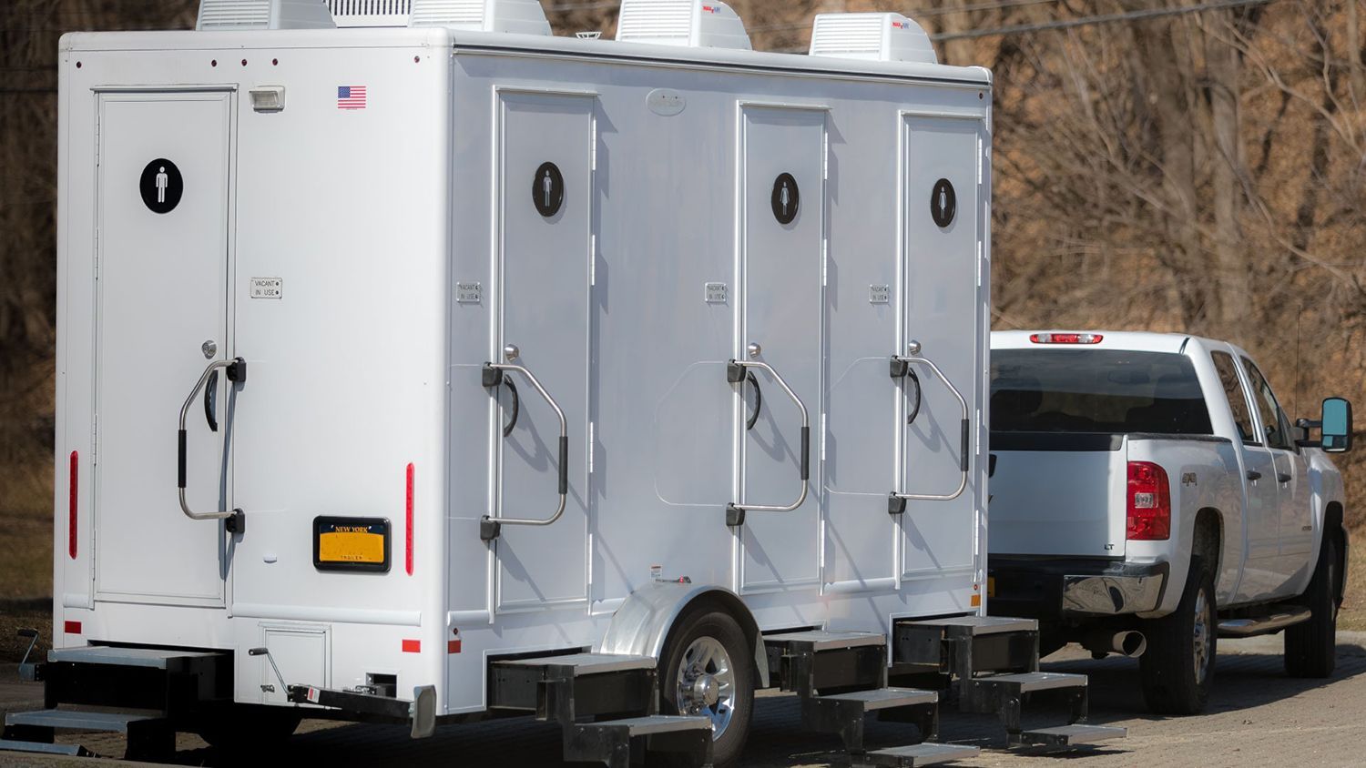 A white luxury portable restroom trailer