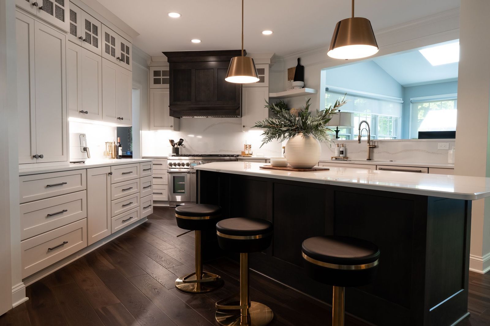A kitchen with a large island and stools