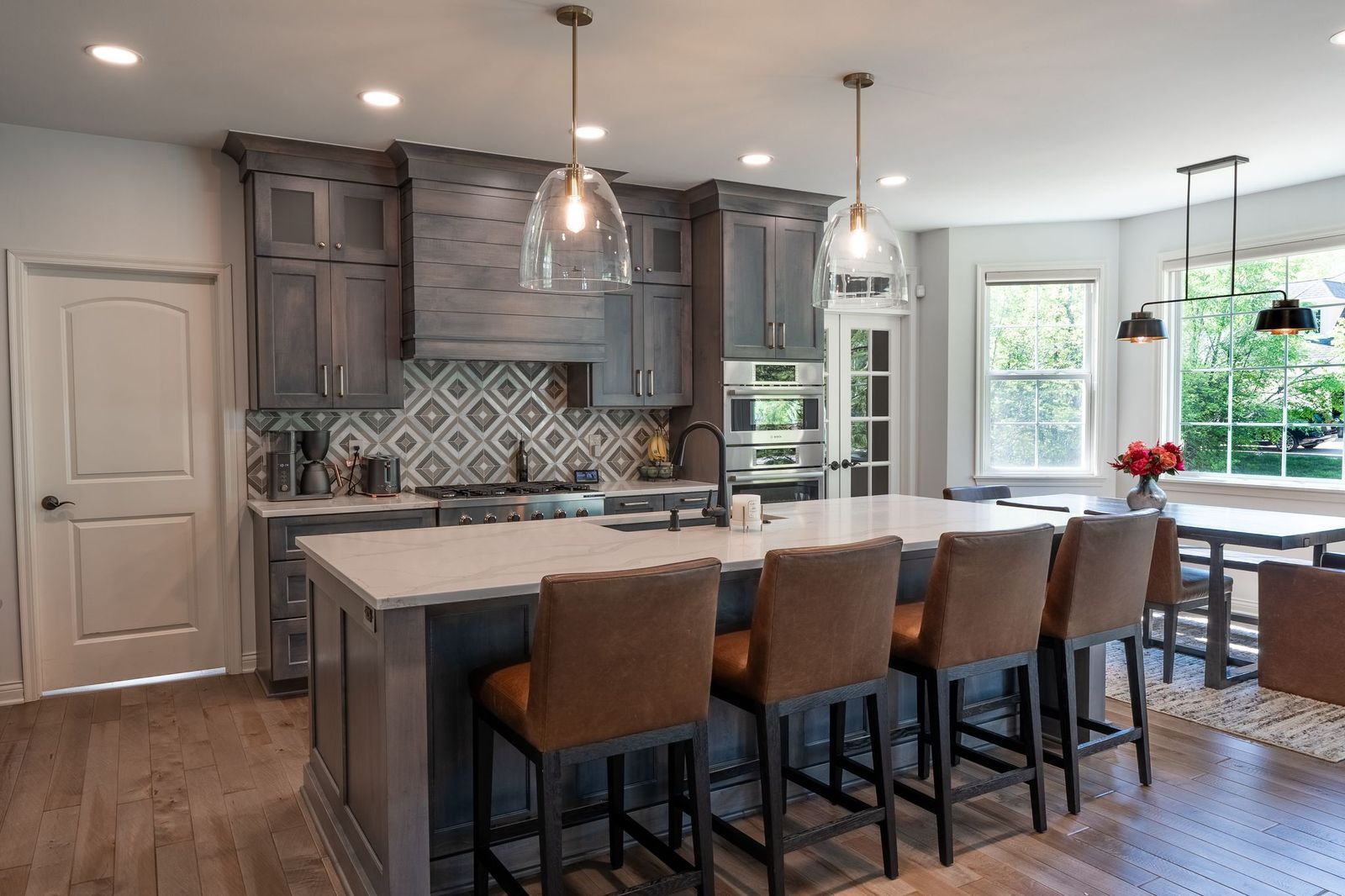 A kitchen with a large island and stools