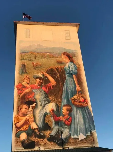 A painting of a family on the side of a building