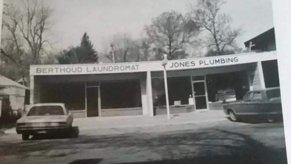 A black and white photo of a laundromat and jones plumbing.