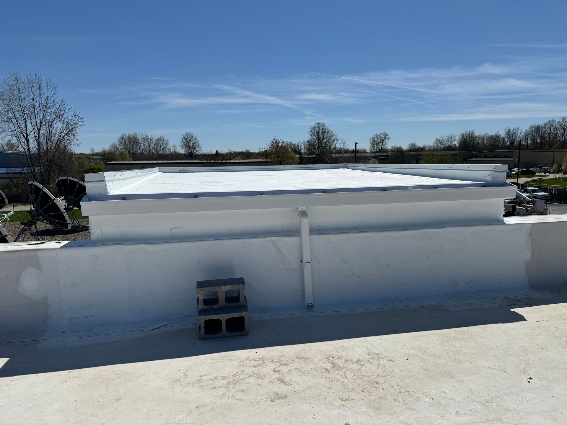 A white roof with a blue sky in the background