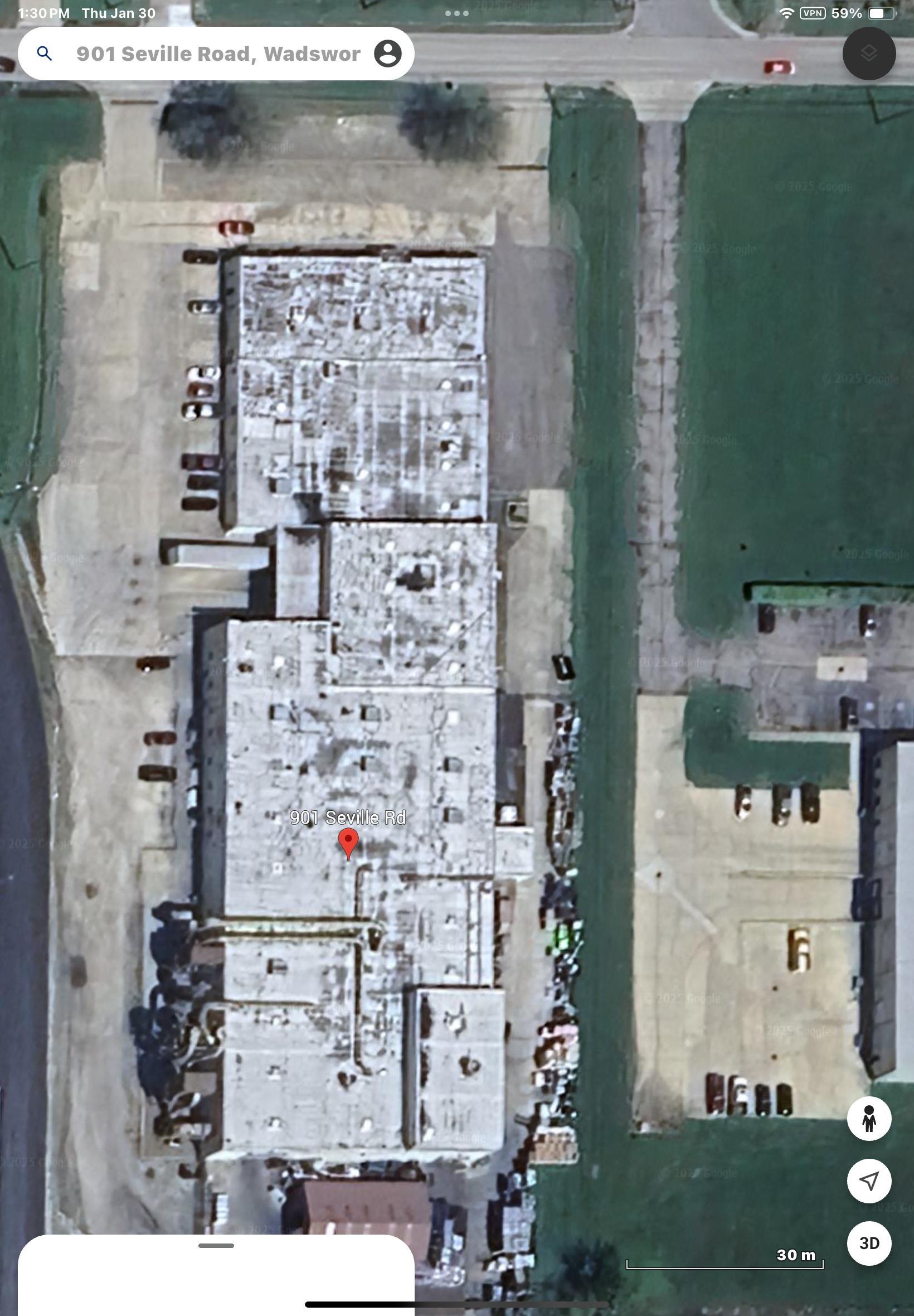 An aerial view of a building with a red circle on the roof