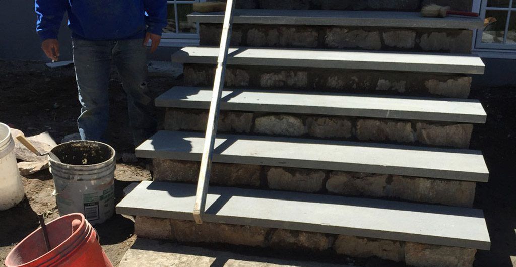 Stone Staircase Entrance with Wrought Iron Railing