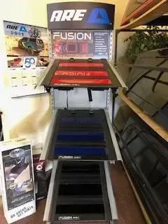ARE Fusion display with tiered truck bed covers in showroom.
