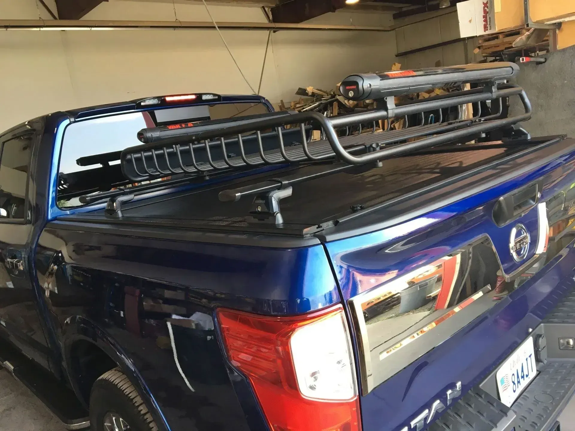 Dark blue truck with a black cargo rack mounted on a tonneau cover.