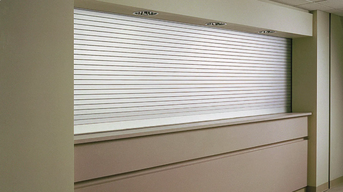 White and tan built-in counter with a blurred, patterned panel above, in an interior setting.