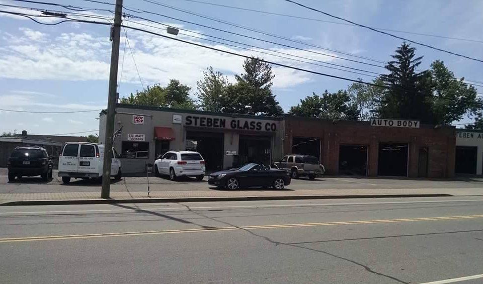 A car is parked in front of a store called stephen glass co.
