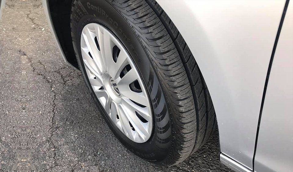 A close up of a tire on a silver car