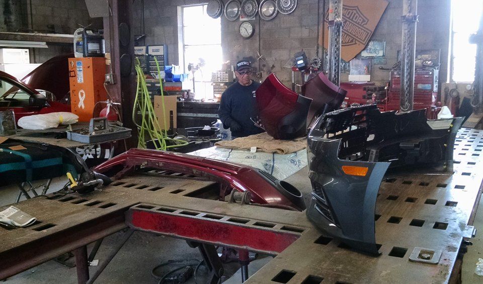 A man is working on a car in a garage
