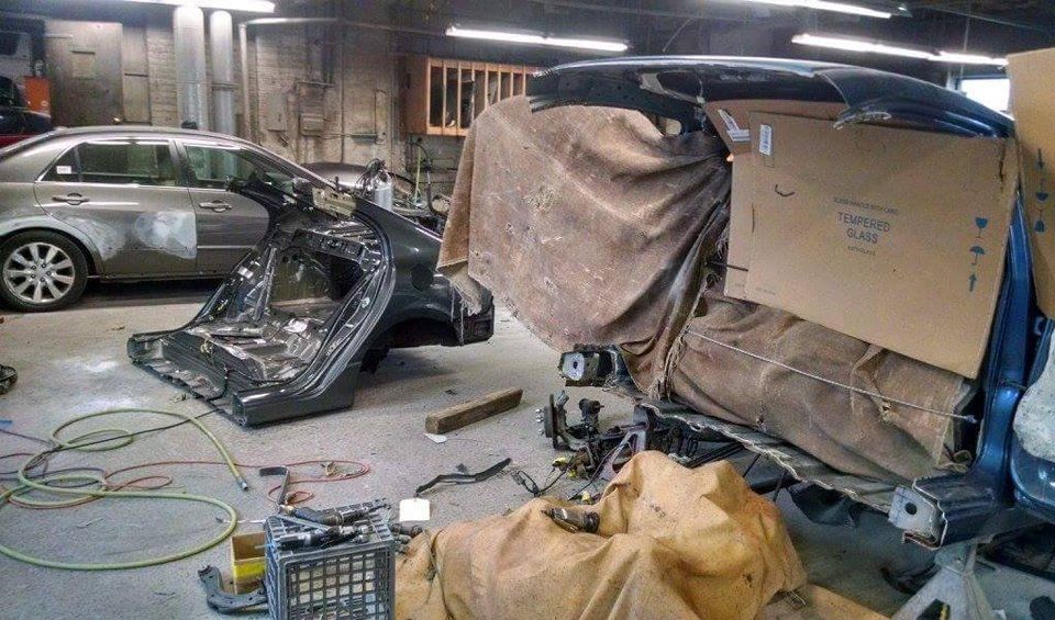 A car is being worked on in a garage.