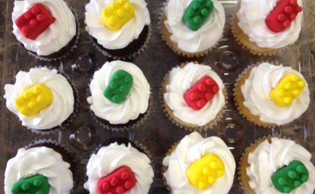 Cupcakes with white frosting and lego bricks on top