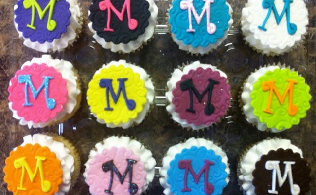 A bunch of cupcakes with the letter m on them