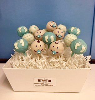 A bunch of baby cake pops are sitting in a white bowl.