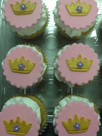 A bunch of cupcakes with crowns on them
