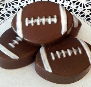 Four chocolate footballs are stacked on top of each other