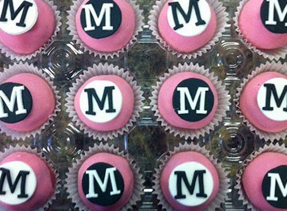 A bunch of cupcakes with the letter m on them
