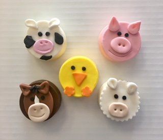 A cow a pig a horse a chicken and a sheep are sitting on a table