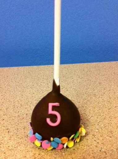A chocolate cake pop with the number 5 on it