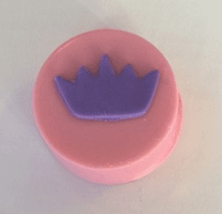 A pink circle with a purple crown on it