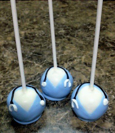 Three blue and white cake pops with headphones on them