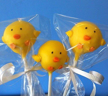 Three yellow chicken cake pops wrapped in plastic