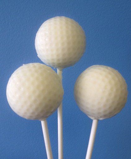 Three white golf balls on white sticks on a blue background