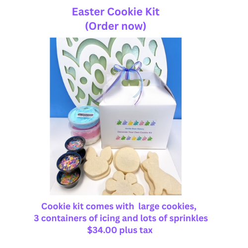 Easter cookie kit with cookies, icing, and sprinkles, in a white box with a blue ribbon.