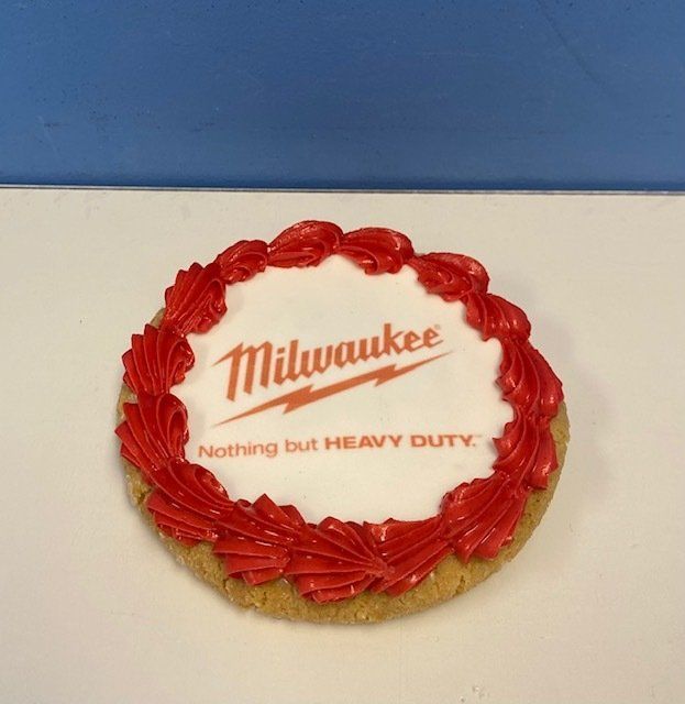 A cookie with a milwaukee logo on it