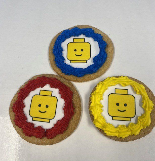 Three cookies with lego faces on them
