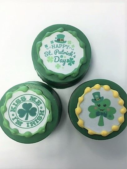 Three cookies with shamrocks and the words happy st. patrick 's day on them