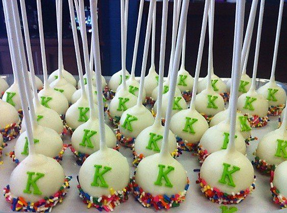 A bunch of cake pops with the letter k on them